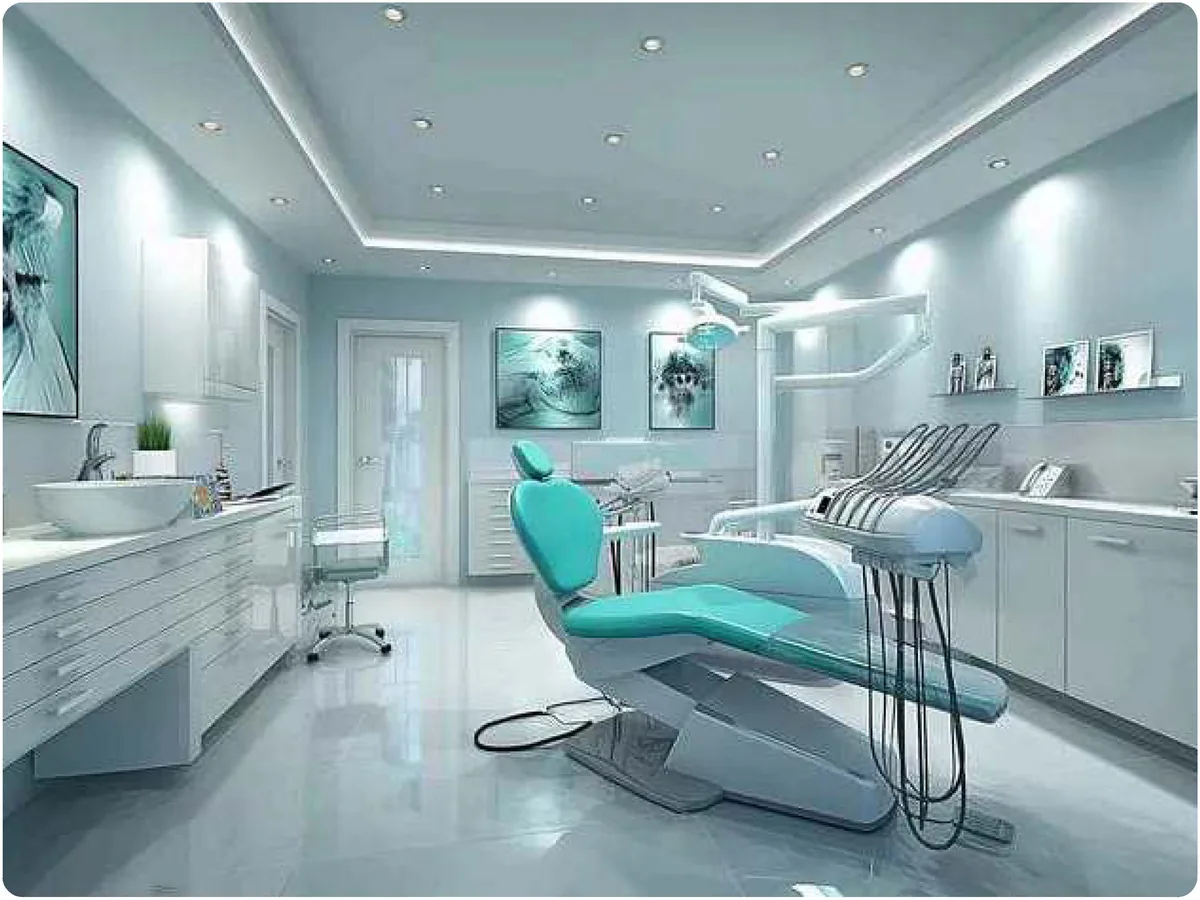 Modern dental operatory with a treatment chair, overhead light and built-in cabinetry